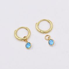 Swiss Blue Topaz charms for earrings (Pair) ✪Gemstone: Natural Swiss Blue Topaz . ✪Metal: 18k solid yellow gold. ✪Stone size: 4 mm. ✪Stone Shape : Round  ✪Stone Weight : 0.50 Ct. ✪ Charm Weight : 0.350 Gram ✪Charm + Hoop Weight : 1.350 Gram Approx. ✪Charm Length : 9.5 mm. ✪Charm width : 4.7 mm. ✪Bail size inside : 2.5 mm. ✪Fit Up To 2 mm Wide Hoops. ✪Hoop Size inside : 8 mm. ✪Hoop Width : 1.5 mm ✪Setting type: Bezel wire setting. If you need any other preferred stone please contact us. Swiss Blue Topaz benefits - *Swiss Blue Topaz is known to soothe, recharge, heal, stimulate, and redirect the energies of the body to where they're required the most.  *It's a stone that will enhance forgiveness and truth, and bring a lot of joy, abundance, generosity, and good health.  *It's known as the ge Bezel Wire, Blue Topaz Earrings, Gold Gift, Topaz Earrings, Swiss Blue Topaz, December Birthstone, Huggie Hoop Earrings, Charm Gift, Solid Yellow