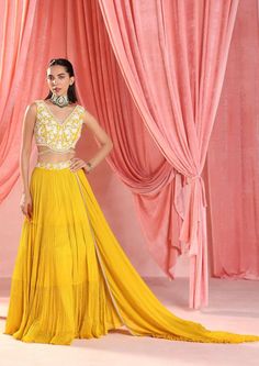 Embellished choli with tassels paired with an embellished tiered skirt and dupatta with ruffles. Designer Long Skirt Dress With Sheer Dupatta, Designer Dresses With Sheer Dupatta And Long Skirt, Sheer Dupatta Long Skirt Dress For Reception, Reception Dress With Sheer Dupatta And Long Skirt, Reception Dress With Sheer Dupatta, Floor-length Skirt Set With Sheer Dupatta For Reception, Elegant Festive Choli With Tiered Skirt, Elegant Floor-length Skirt Set With Dupatta, Party Dress With Dupatta And Long Skirt