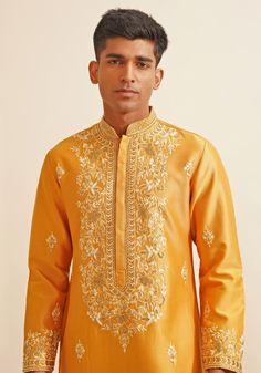 Introducing a stylish Mustard Yellow Chinese Collar Kurta Set, intricately designed with a Chinese collar, metallic silver buttons, and exquisite hand-embroidered details for a unique and elegant look. Paired with white pants, this vibrant yellow kurta set is perfect for Mehendi, Haldi, or Sangeet events, offering a blend of tradition and contemporary style. Composition : Chanderi Silk Care: Dry Clean Only and Vacuum Storage This product can be customized for sleeves, length and colour Delivery : 4-6 weeks as the product is hand crafted. Check Size Guide or choose MySize for free customisation (All Sizes above XL can be made at 15% additional cost) For more information and sizes please contact fabiliciousfashion@gmail.com or visit our Copenhagen studio. About the Designer : Shreyansh, a di Collar Kurta, Yellow Kurta, Chinese Collar, Indian Wedding Wear, Kurta With Pants, Floral Vine, Silver Buttons, Kurta Set, Pants Pattern