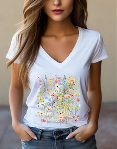 Elevate your wardrobe with our Fall In Love With Flowers women's deep v-neck t-shirt - a timeless piece designed for a modern feminine fit and unparalleled comfort. Crafted from 100% Airlume combed and ring-spun cotton, this favorite offers a lightweight feel and durability. With side seams for a flattering shape, tape-reinforced shoulders, and ribbed collar, it's a must-have in every woman's collection. Embrace style and comfort effortlessly - order your Fall In Love With Flowers tee today! Spring V-neck Graphic Tee, Summer Graphic Tee V-neck T-shirt, Summer Graphic Tee With V-neck, White Cotton V-neck Short Sleeve Top, White Cotton V-neck Top With Short Sleeves, Spring Cotton V-neck T-shirt, Spring Graphic Tee With V-neck, Fitted V-neck Graphic Tee, Spring V-neck Cotton T-shirt