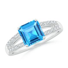 Elegantly designed in 14k white gold, this solitaire ring with diamond shoulders showcases an emerald-cut Swiss blue topaz in a double claw prong setting. The diamonds are prong set on the lustrous split shank. Swiss Blue Topaz Ring, Split Shank Ring, Claw Prong, Ring With Diamond, Swiss Blue Topaz, Split Shank, 1 Carat, Solitaire Ring, Emerald Cut