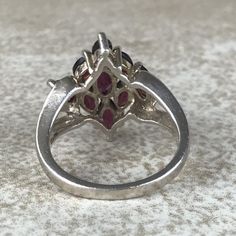 Garnet Cluster Ring Sz 7/Sterling Silver/Genuine 5.4ct Marquise Cut/Rhodolite Garnet/Signed/Pink Purple Garnet/Vintage Estate/Ring For Women Description Beautiful rhodolite garnet ring in excellent vintage condition. A total of 5.4ct of genuine, marquise cut garnet set in designer signed stamped 925 sterling silver setting. Face of ring measures 20mm from top to bottom and has a weight of 5.1g. Gorgeous pink purple color and fantastic sparkle! Size 7. All Gems tested with Presidium Gem Tester. A Formal Marquise Ruby Ring With Accent Stones, Silver Multi-stone Cluster Ring, Fine Jewelry Marquise Ruby Ring With Multi-stone, Marquise Multi-stone Ruby Ring, Marquise Multi-stone Ruby Ring In Fine Jewelry Style, Pink Marquise Ruby Ring For Formal Occasions, Formal Multi-stone Pink Ruby Ring, Formal Marquise Pink Ruby Ring, Collectible Cluster Gemstone Rings