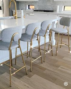 a row of bar stools sitting on top of a kitchen counter