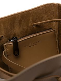 Finely crafted from 100% camel brown leather Exquisite tonal stitching enhances the design Adjustable shoulder strap for comfort and versatility Chic Monili chain detail adds a touch of luxury Elegantly debossed front logo showcases brand identity Spacious main compartment for everyday essentials Internal pouch to keep items organized Premium suede lining for an extra touch of elegance Secure drawstring fastening to safeguard your belongings Includes a protective dust bag for storage and preserv Holdall Bag, Debossed Logo, Oversized Tote Bag, Latest Bags, Brown Leather Shoulder Bag, Leather Cap, Leather Bucket Bag, Leather Bucket, Purple Bags