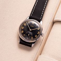 Step into a piece of history with this exceptionally rare Recta military watch, crafted in Switzerland in the 1940s. Distinguished by its steel case with a unique diameter of 35 mm, this timepiece stands out for its rarity and commanding presence. Featuring an original dial adorned with a beautifully aged patina, it tells a story of its era as much as it does time. The watch operates smoothly, having been meticulously serviced by a master, ensuring it remains in excellent working condition. This Vintage Black Watch With Polished Finish, Vintage Black Watch Accessories With Polished Finish, Black Vintage Watch Accessories With Polished Finish, Vintage Military Watches, Watch Gift For Him, Watch Gift Box, Army Watches, Swiss Army Watches, Premium Watches