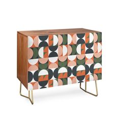 an orange, black and white cabinet with geometric designs on the sideboard is shown