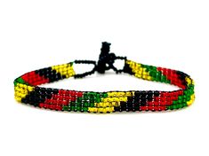 One Love Beaded Jamaica Bracelet - Rastafarian Jewelry - Jamaican Flag Colors - African Bracelet - For Men & Women Wrap your wrist in Jamaica, mon', with these brilliantly beaded bracelets! Both casual and trendy, these bracelets make a great every day accessory. *Please note that all of our items are handcrafted and unique to each piece. Also, colors may vary slightly based on your device. Like what you see here? Check out all of our beautiful handmade products at www.KAQCHI.com and follow Jamaican Beaded Jewelry, Adjustable Black Wristband With Colorful Beads, Adjustable Black Braided Bracelet With Colorful Beads, Adjustable Black Friendship Bracelet With Colorful Beads, Festival Black Braided Bracelets With Round Beads, Black Braided Bracelet With Round Beads For Festivals, Jamaica Bracelet, African Bracelet, African Bracelets