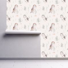 an owl themed wallpaper with leaves and flowers on it, next to a white shelf