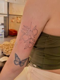 a woman with a butterfly tattoo on her arm