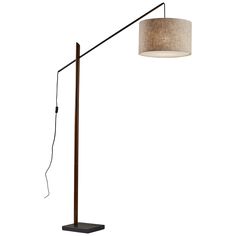 a floor lamp with a fabric shade on the bottom and a wooden pole underneath it