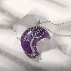 PLEASE NOTE: Our crystal stones are natural minerals and each crystal is unique. The internal ice cracks, pits, mineral points, and color differences of natural crystals are all formed naturally and are normal phenomena, which will not affect the efficacy, beauty and value of the crystal at all.The crescent moon represents receptiveness and reflection, power and change. Combined, the tree of life and the moon form a potent symbol of connection and personal development. This necklace features the Spiritual Amethyst Crystal Necklace Gift, Spiritual Quartz Gemstone Crystals, Mystical Round Crystal Necklaces For Healing, Amethyst Raw Stone Crystals For Gift, Lavender Spiritual Crystal Pendant Necklace, Silver Nature-inspired Crystal Necklace For Healing, Quartz Crystal Necklace With Raw Stone For Healing, Nature-inspired Silver Crystal Necklace For Healing, Mystical Amethyst Necklace For Gift