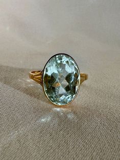 Antique 14k yellow gold ring from Czarist Russia. This heirloom features an impressive faceted oval-cut aquamarine rested on an open-work gallery. Great antique conditionSize: 8.5 resizable*Weight: 3.3 gramsBand: 14.7 mm (front), 1.7 mm (back)Aquamarine: 13.3 mm x 9.0 mm Hallmarks: 585 for 14k, Russian hallmark Oval Topaz Ring With Center Stone For Formal Occasions, Art Deco Oval Topaz Ring With Center Stone, Oval Topaz Ring For Formal Occasions, Art Deco Blue Topaz Oval Jewelry, 14k Gold Heirloom Oval Topaz Ring, Oval Heirloom Topaz Ring For Formal Occasions, Formal Oval Topaz Gemstone Ring, Heirloom 14k Gold Oval Topaz Ring, Formal Gold Rings With Green Amethyst