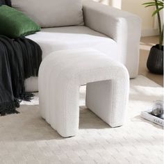 a white ottoman sitting on top of a rug