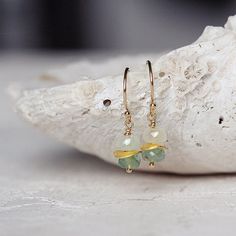 Back in stock, these gorgeous little Gold Emerald Earrings add instant elegance and delicacy. Featuring genuine, quality, hand cut, Emerald precious stones on 14k gold ear wires. Tasteful and chic - these dainty green earrings are reminiscent of nature's beautiful landscape - forests, mountains, meadows, trees, seas - and will help you feel connected to nature as you go about your day. Perfect for the coming season, they look great with anything from structured and tailored city-chic outfits to Gold Emerald Earrings, Emerald Drop Earrings, Emerald Jewellery, Emerald Earrings Drop, Jewelry Emerald, Wire Jewellery, Earring Ideas, May Birthstone, Earrings Dainty