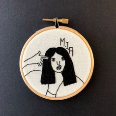 a woman's hand embroiderying on a hoop with the words mr and mrs