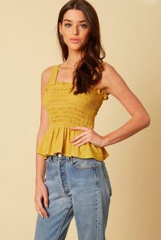 Final Sale - Get it before it's gone! Make moves in the Elsa Mustard Peplum Tank Top! We are loving this top for summer daze! Light-weight dijon mustard smocked fabric with white stitching forms a tank top bodice. Ruffled hem and attached wide straps. Pullover style. DETAILS & CARE Rayon. Machine Wash Cold. Imported. ORDERS, SHIPPING & RETURNS Orders, Shipping, & Returns Affordable Peach Sleeveless Top, Cheap Ruffled Peplum Top For Brunch, Affordable Yellow Summer Tops, Cheap Feminine Peplum Top For Summer, Affordable Flowy Yellow Tops, Affordable Casual Mustard Tank Top, Cheap Yellow Tops For Vacation, Cheap Mustard Tops, Cheap Tank Top With Smocked Bodice