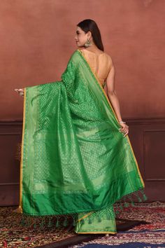 Radiate elegance on festive occasions in this beautiful green Katan silk Banarasi saree with over all zari work. The saree has yellow edging. It comes with a matching blouse piece. Disclaimer: The shown stitched blouse on the model is for display purpose only. The saree comes with a matching blouse piece and finished with fall and piko Disclaimer: The actual product may vary slightly from the image. These are custom orders, hence expect slight variation in color, placement of the motif or buta. Green Pre-draped Saree With Meenakari For Puja, Green Dola Silk Pre-draped Saree With Dupatta, Festive Green Pre-draped Saree With Zari Weaving, Green Semi-stitched Pre-draped Saree With Meenakari, Green Dola Silk Pre-draped Saree For Diwali, Green Pre-draped Saree With Zari Weaving For Diwali, Green Bollywood Pre-draped Saree With Meenakari, Green Paithani Silk Pre-draped Saree With Self Design, Green Chanderi Pre-draped Saree For Puja