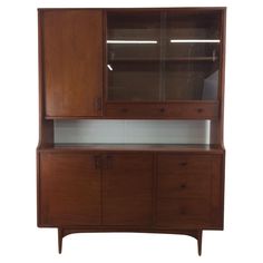 a wooden cabinet with glass doors and drawers