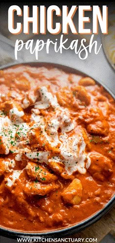 chicken paprikash in a skillet with sour cream and parsley on top