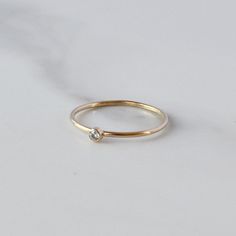 A super cute, minimalist CZ stone ring gives you that barely there feel, with a touch of sparkle. Looks great alone or added to your daily stack! 14K Gold Filled Band is 1mm, CZ stone is 2mm Listing is for ONE RING Gold Filled has 100 times more gold than gold plated jewelry and will not chip or fade with wear! You can swim/shower, etc just like you would with solid gold. Gold filled wire is created by taking a sheet of 14 karat gold and bonding it through extreme heat and pressure to a core of London Topaz Ring, Gold Filled Ring, Ring Stacking, Gold Ring Stack, Rose Gold Band, Cubic Zirconia Rings, Minimalist Ring, Ring Dainty, Blue Jewelry