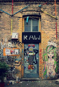 an old brick building with graffiti on it