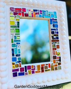 a mirror made out of different colored tiles