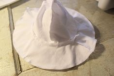 a white hat sitting on top of a wooden table