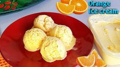 orange ice cream on a red plate next to sliced oranges and an orange slice