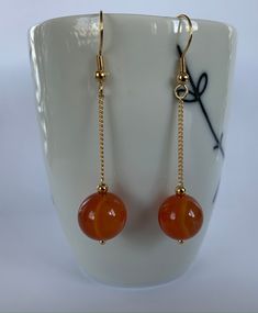 Hand made with love Earring length: 5 cm 10 mm carnelian beads  Gold plated chain and hoops To see all jewelry, check the list here https://www.etsy.com/ca/shop/EmilyGemJewelry Wire Wrapped Agate Dangle Jewelry, Spiritual Agate Dangle Jewelry, Red Carnelian Round Bead Jewelry, Adjustable Gemstone Bead Drop Earrings, Agate Jewelry Gift, Wire Wrapped Agate Jewelry With Round Beads, Round Agate Jewelry For Gift, Wire Wrapped Round Agate Jewelry, Gemstone Bead Drop Earrings For Gifts