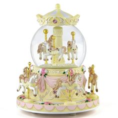 a snow globe with carousel horses inside on a white background, in the shape of a christmas ornament