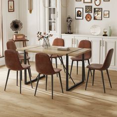 a dining room table with chairs and pictures on the wall in the backround