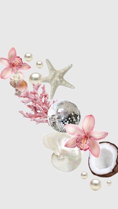 some pink flowers and pearls are on the table next to a mirror ball, starfish, and seashells