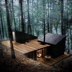 the cabin in the woods is made out of wood and has been built into the ground