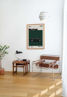 a living room filled with furniture and a poster on the wall