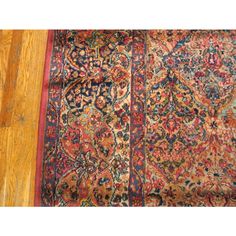 an antique persian rug is laying on the floor next to a hardwood flooring plank