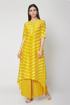 Sunshine yellow high-low kurta with all-over leheriya print. Paired with bandhej print palazzo pants.
Component: 2
Printed
Neckline: Round
Sleeve Length: Half
Fabric: Modal Satin
Color: Yellow
Asymmetric hem
Detailing at neck and sleeves
Long kurta - Aza Fashions Yellow Kurta Sets For Women, Lehriya Kurti Designs, Bandhni Kurti Designs Latest, Lehariya Kurti Designs, Haldi Wedding, Printed Kurti Designs, Simple Kurtis, Yellow Kurti, Simple Kurta