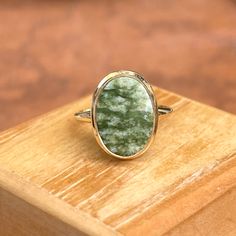 Estate/ vintage 10KT yellow gold oval, genuine green jade ring. Beautiful, earthy green jade set on a low profile setting. Size 6 Weight: 2.60 grams Band width: 2mm Jade measures: 14mm x 10mm Stamped 10KT Excellent estate condition Oval Jade Jewelry With Natural Stones, Jade Rings With Polished Finish In Oval Cabochon Shape, Jade Rings With Polished Finish, Oval Cabochon, Jade Oval Cabochon Rings With Polished Finish, Oval Cabochon Jade Rings With Polished Finish, Oval Jade Jewelry With Large Stone, Classic Green Jewelry With Large Stone, Green Oval Gemstone Rings, Oval Green Jewelry With Polished Finish