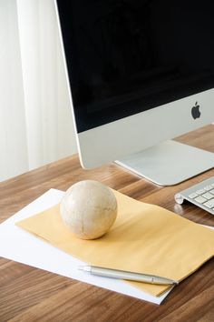 an apple computer sitting on top of a wooden desk next to a keyboard and mouse