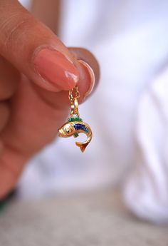 Elevate your jewelry collection with my exquisite Handmade 14k Gold Enamel Koi Charm, a perfect blend of artistry and luxury. Meticulously crafted by me, this charm features a vibrant koi fish, symbolizing perseverance, strength, and good fortune. The 14k gold setting provides a rich, timeless foundation, while the hand-painted enamel detailing brings the koi to life with its vivid colors and intricate design. This charm is more than just a piece of jewelry--it's a meaningful talisman that carries the deep symbolism of the koi fish, making it an ideal gift for someone who embodies resilience or is embarking on a new journey. Whether added to a bracelet or worn as a pendant, this charm will infuse any outfit with elegance and a touch of cultural significance. **EACH CHARM IS UNIQUELY CRAFTE Enamel Fish-shaped Jewelry For Gifts, Enamel Fish-shaped Jewelry As Gift, Fish-shaped Enamel Jewelry As A Gift, Fish-shaped Enamel Jewelry For Gifts, Fish-shaped Enamel Jewelry Gift, Koi Fish Jewelry, Gold Koi Fish, Gold Koi, Fish Jewelry