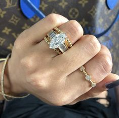 a woman's hand holding a diamond ring