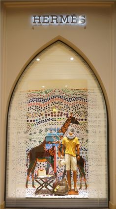 a window display with a horse and giraffe in it