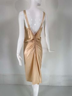 For Sale on 1stDibs - John Galliano, old Hollywood glamourous gold satin evening dress with a plunge V neckline and chiffon woven shirred center front, The back features a row Ruched V-neck Satin Dress For Formal Occasions, Chic Gold Evening Dress For Gala, Gold V-neck Evening Dress For Summer, Gold Backless Evening Dress For Cocktail, Backless Ruched Satin Dress For Evening, Ruched Backless Satin Dress For Evening, Gold Backless Cocktail Dress, Gold Backless Cocktail Evening Dress, Elegant Ruched Silk Satin Dress