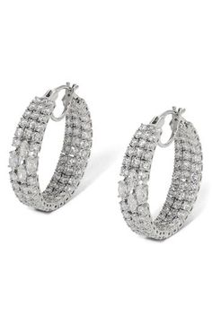 Cubic zirconia lines the inner and outer circemferences of these hoop earrings in a variety of light-catching cuts. 1 1/4" hoop diameter; 1/4" width 18k-gold plate or rhodium plate/cubic zirconia Imported Oval Cubic Zirconia Hoop Earrings With Diamond Cut, Oval Cubic Zirconia Hoop Earrings Fine Jewelry, Hoop Earrings With Diamond Cut Cubic Zirconia, White Gold Cubic Zirconia Hoop Earrings, White Gold Hoop Earrings With Cubic Zirconia, White Gold Cubic Zirconia Hoop Earrings For Pierced Ears, Hoop Cubic Zirconia Jewelry With Diamond Cut, Cubic Zirconia Diamond Cut Hoop Earrings, Diamond Cut Cubic Zirconia Hoop Earrings