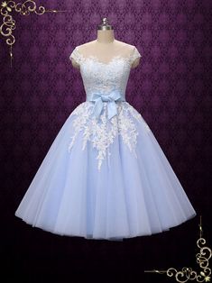 a light blue dress with white lace on the top and a bow at the waist