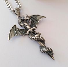 ★ Dragon Pendant ★ Handcrafted Dragon with Sword pendant/necklace for Men and Women. * Materials/Finishes ➤ Artificially Aged (Black/Grey Oxidized) Silver 925 * Dimensions ➤ ~ 5.5 x 4.2 x 1.0 cm (~ 2.2 x 1.7 x 0.4 inches)/Bail: Suitable for up to ~ 4.5 mm (~ 0.18 inches) Chain * Weight: ~ 15 grams (in Silver 925) ----------------------------------------------------------------------------- IMPORTANT NOTES: ----------------------------------------------------------------------------- ➤ When buyin Silver Dragon, Precious Jewels, Dragon Pendant, Oxidized Silver, Pendant Silver, Stainless Steel Chain, Men Necklace, Silver 925, Silver Color