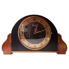 a black and gold clock with musical notes on the face is shown against a white background