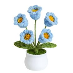 crocheted blue flowers in a white vase