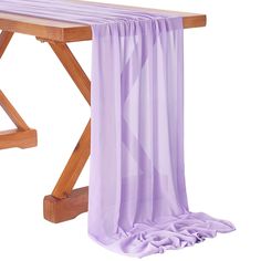 a wooden bench with purple sheer curtains hanging from it's sides, on a white background