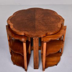 a set of four wooden tables sitting on top of each other