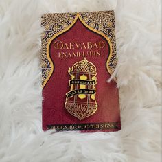 a red book sitting on top of a white fur covered floor